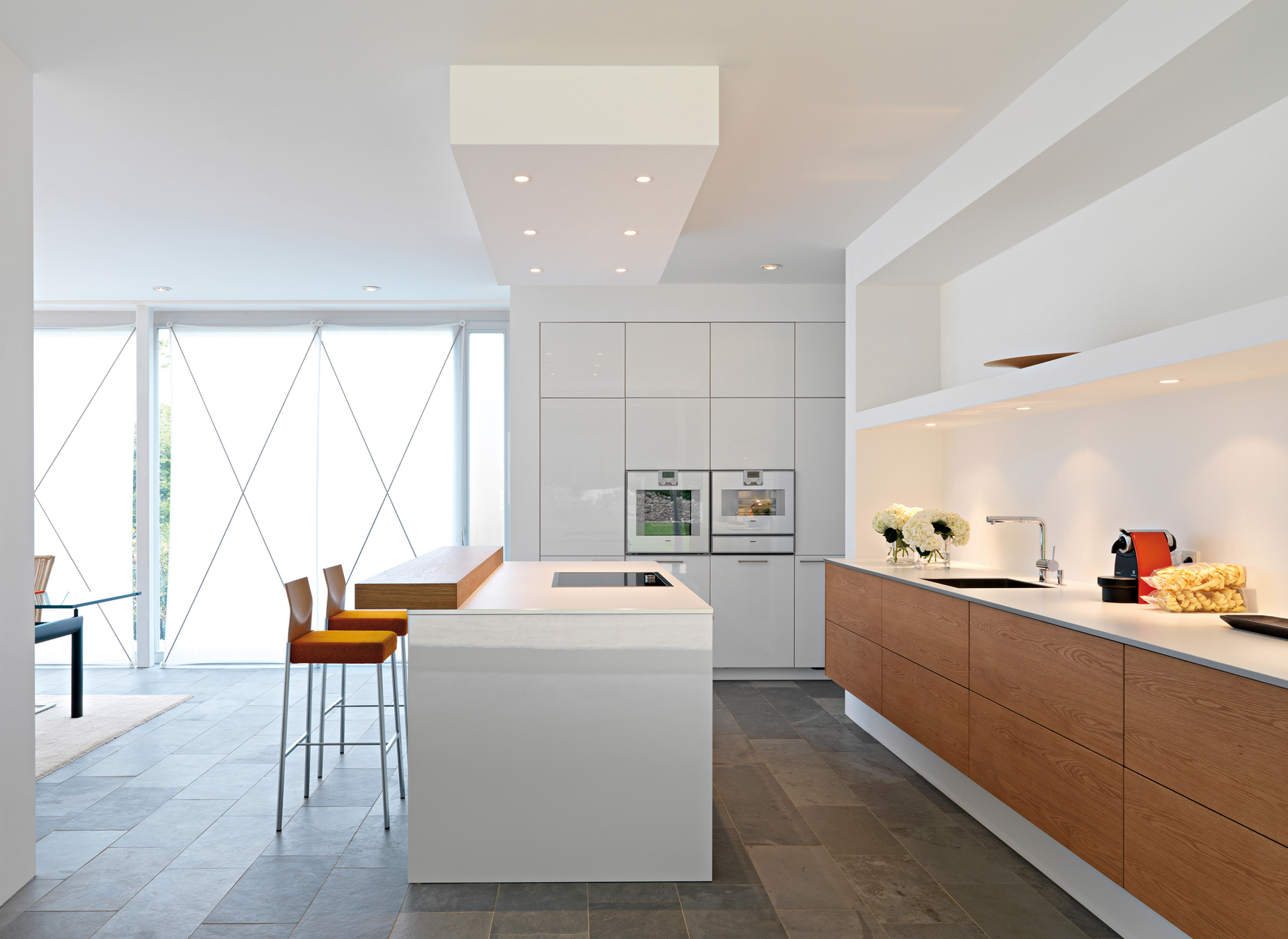 Radiant white and gleaming smooth surfaces are the main features of the restrained installation.